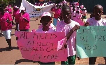 Children show of placards during a charity walk to support cancer efforts in 2010.