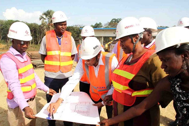 Project manager Infratech SK Saxena shows minister Muloni drawing of the tunnels