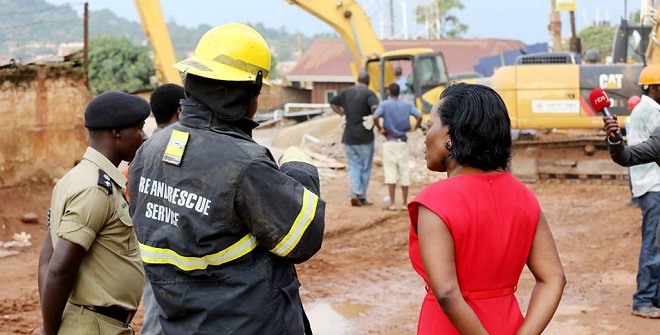 KCCA's Musisi being briefed by the rescue teams. Little home remains for any other survivors. PHOTOS BY KCCA