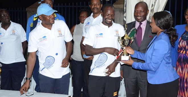 Buganda Kingdom’s Joan Nassolo hands Kawooya a trophy. INDEPENDENT PHOTO
