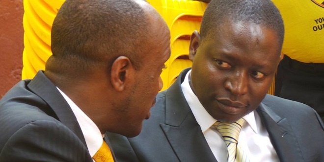 Minister Bahati (right) discusses with colleague Banyenzaki at a recent event. Bahati now to vet ministers
