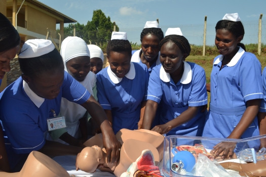 Trainee midwives demonstrating the childbirth process using a birth simulator in Kampala, Uganda. PHOTO UN