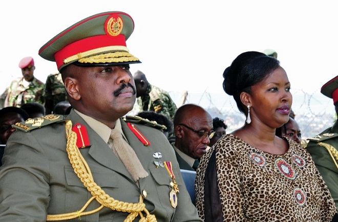 The son of Uganda's President Yoweri Museveni, Major General Muhoozi Kainerugaba (L) and his wife Charlotte Kutesa Kainerugaba (R) attend a ceremony in which Kainerugaba is promoted from Brigadier to Major General at the country's military headquarters . AFP PHOTO