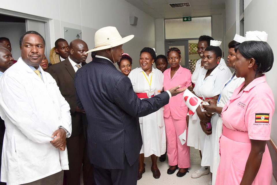 Museveni talking delivery of services with nurses on a visit this week.