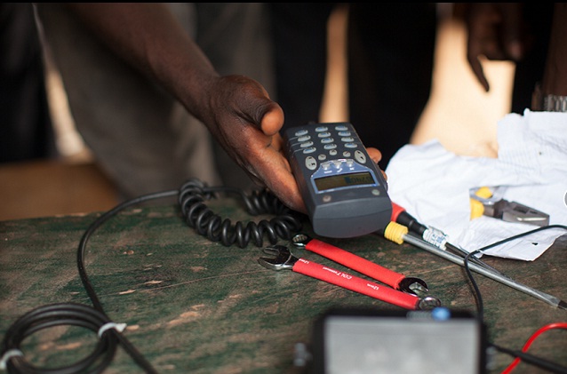 A technician sets up a phone radio in Centra Africa Republic. PHOTO BY INVISIBLE CHILDREN