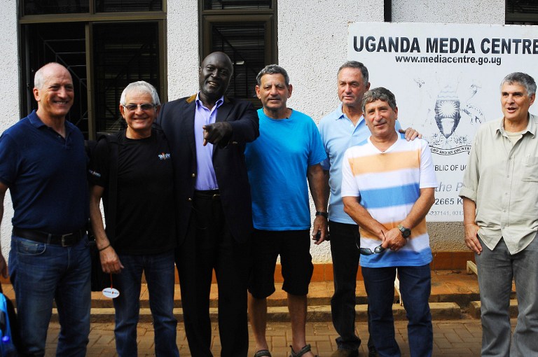A picture taken on June 14, 2016 shows (LtoR) Eyal Oren, Shlomo Carmel, Jaffer Amin, Amjon Peled, Alex Davidi, unidentified, and Amir Ofer, members of the former Israeli Commandos and Entebbe hostages, posing in Kampala ahead of the 40th anniversary of their rescue. Skimming above the choppy waves through the dark, the four planes swooped in low over Lake Victoria, packed with over 200 elite Israeli commandos on a daring raid to free hijacked hostages -- the July 4, 1976 operation at Uganda's Entebbe airport that has gone down in special forces legend. / AFP PHOTO / RONALD KABUUBI
