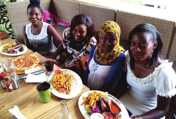 Ladies enjoy their snacks. Health experts say fast foods are okay if eaten in small amounts and with lots of vegetables and fruits. PHOTO Independent/Flavia Nassaka