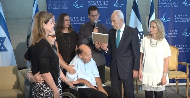 Peres with veterans of the Entebbe Raid earlier this year.