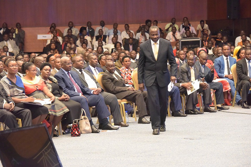 Minister Kasaija walks with a swag after delivering the budget. PHOTO PPU