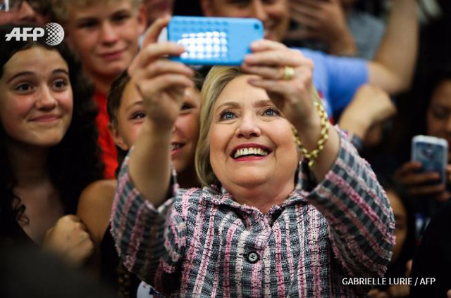 Ecstatic Clinton takes a selfie with supporters after winning California Democratic primary 