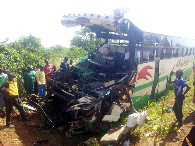 Residents look at the wreckage of the bus after it hit an elephant