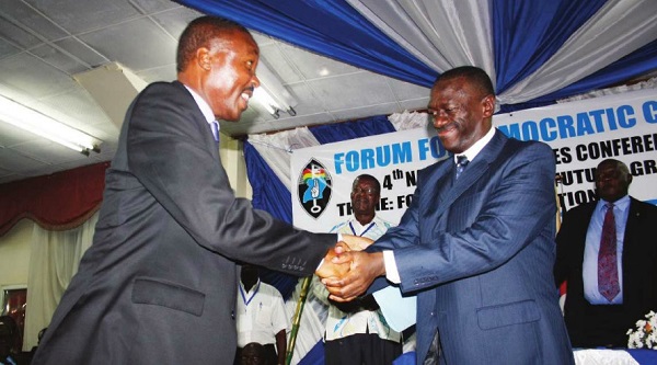 Dr Kizza Besigye congratulates Gen Muntu upon winning the FDC party presidency at Mandela Stadium. FILE PHOTO