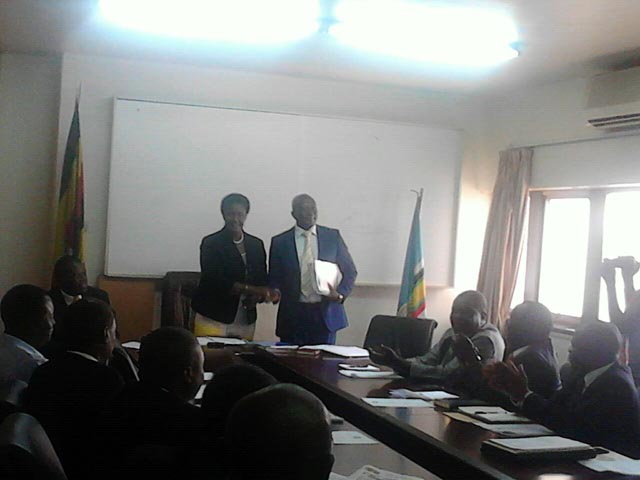 Minister Amelia Kyambadde hands over to state minister of cooperatives Ngobi Ggume. Photo by Charlotte Ninsiima