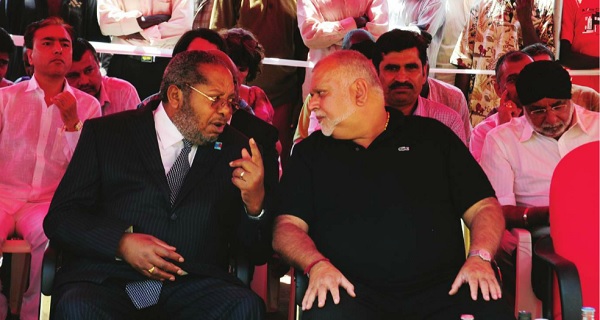 Crane Bank's Sudhir Ruparelia (R) listens to Bank of Uganda Governor Emmanuel Tumusiime -Mutebile at the opening of a new branch in Jinja. INDEPENDENT/JIMMY SIYA