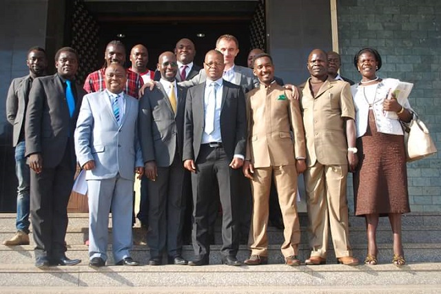 FUFA president Moses Magogo (centre) flanked by MP Obua and Ssewanyana, coach Micho and other FUFA officials and MPs at parliament on Tuesday. 