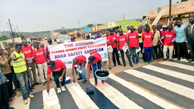 USPA memebers paint a zebra crossing while below, some of the vehicles impounded in Nakasongola. PHOTOS BY UPF & UNRA