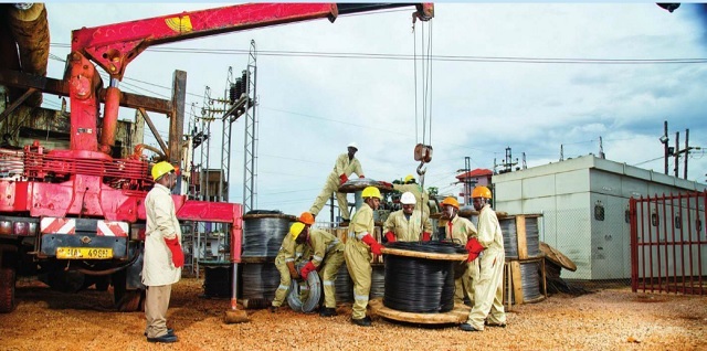 Umeme engineers install equipment as part of the network expansion project. Courtesy Photo