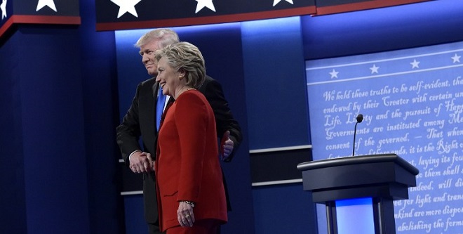 Republican presidential nominee Donald Trump(L) shakes hands with Democratic presidential nominee Hillary Clinton at the start of the first presidential debate at Hofstra University in Hempstead, New York on September 26, 2016. / AFP PHOTO / MANDEL NGAN