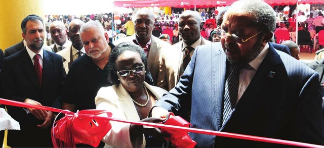 Good times: Bank of Uganda governor Tumusiime Mutebile launches a Crane Bank branch as Sudhir Ruparelia (2L) looks on. The relationship between the regulator and the bank have fallen on hard times in recent month Independent/Jimmy Siya