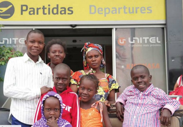 Musabyenamariya Fratenata and her children at the airport in Angola prior to their departure for Rwanda. UNHCR photo