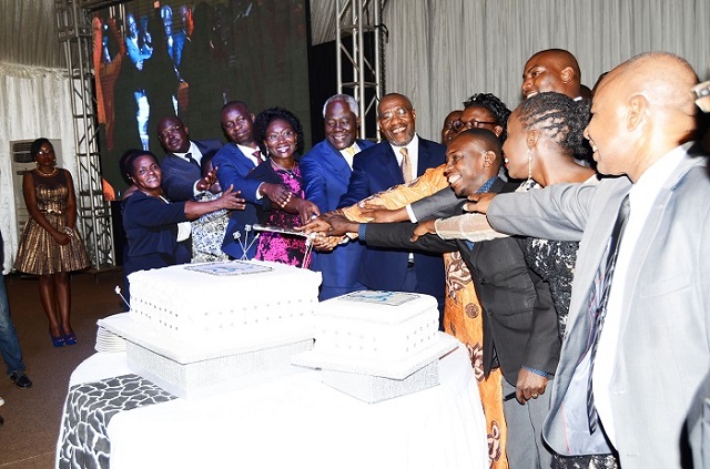 Prime Minister Rugunda, URA board chairman Dr. Simon Kagugube and CG Doris Akol join guests in cutting the 25-year celebrations cake.