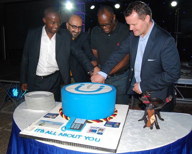 Uganda Telecom MD Shoebridge and other officials cut a cake as the company recognised its top customers in the Customer Appreicaition Week at Sheraton in September. 