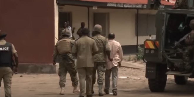 King Mumbere (right) soon after he was arrested yesterday. 