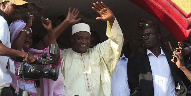 This video grab taken from footage shot by AFPTV shows The Gambia's President-elect Adama Barrow (C) gesturing to the crowd in Kololi on December 2, 2016 following his victory in the polls.  The Gambia's President-elect Adama Barrow was to hold talks with his coalition to plot his transition to power, following a shock election victory that ended the 22-year rule of Yahya Jammeh. The scenes of jubilation on the streets after the results were released gave way to a calm but buoyant mood in the capital Banjul as horsetrading got under way behind closed doors.  / AFP PHOTO / AFPTV / Joe Sinclair